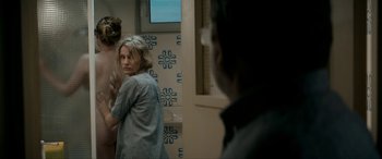 Movie still from “Graduation” (2016), directed by Cristian Mungiu – A woman standing next to a man in a bathroom; Medium shot, Over the shoulder angle