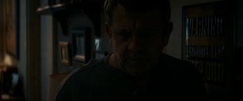 Movie still from “Graduation” (2016), directed by Cristian Mungiu – A person wearing glasses in the dark; Close Up shot, Over the shoulder angle