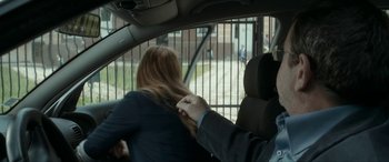 Movie still from “Graduation” (2016), directed by Cristian Mungiu – A man and a woman in the back seat of a car; Medium shot, Over the shoulder angle