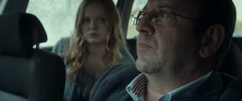 Movie still from “Graduation” (2016), directed by Cristian Mungiu – A man and a woman sitting in the back of a car; Close Up shot, Over the shoulder angle