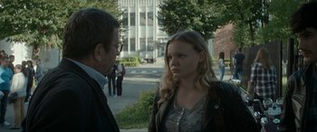 Movie still from “Graduation” (2016), directed by Cristian Mungiu – A man and a woman standing next to each other on a sidewalk; Medium shot, Over the shoulder angle