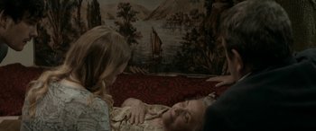 Movie still from “Graduation” (2016), directed by Cristian Mungiu – A woman sitting next to an older woman on a couch; Medium shot, High angle