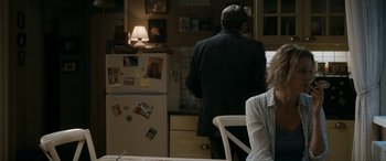 Movie still from “Graduation” (2016), directed by Cristian Mungiu – A man and a woman are standing in a kitchen; Medium shot, Over the shoulder angle