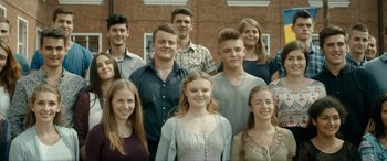 Movie still from “Graduation” (2016), directed by Cristian Mungiu – A group of young people posing for a picture; Medium shot, High angle