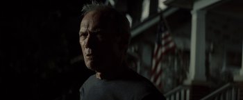 Movie still from “Gran Torino” (2008), directed by Clint Eastwood – An older man is looking at the camera; Close Up shot, Low angle
