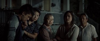 Movie still from “Gran Torino” (2008), directed by Clint Eastwood – A group of women standing next to each other; Medium shot, Over the shoulder angle
