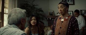 Movie still from “Gran Torino” (2008), directed by Clint Eastwood – A group of people in a living room; Medium shot, Over the shoulder angle