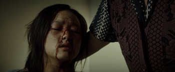 Movie still from “Gran Torino” (2008), directed by Clint Eastwood – A woman with blood all over her face and arm; Close Up shot, Low angle