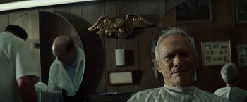 Movie still from “Gran Torino” (2008), directed by Clint Eastwood – An older man sitting in front of two mirrors; Close Up shot, Over the shoulder angle