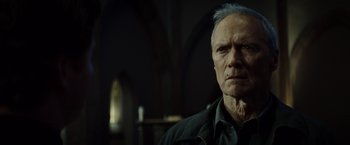 Movie still from “Gran Torino” (2008), directed by Clint Eastwood – An older man is looking at the camera; Close Up shot, Low angle