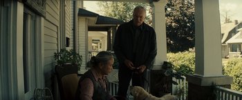 Movie still from “Gran Torino” (2008), directed by Clint Eastwood – A man and a woman standing on a porch with a dog; Medium shot, Over the shoulder angle