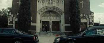 Movie still from “Gran Torino” (2008), directed by Clint Eastwood – Two people are walking down the steps of a church; Extreme Wide shot, Low angle