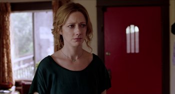 Movie still from “Grandma” (2015), directed by Paul Weitz – A person standing in front of a red door; Close Up shot, Over the shoulder angle