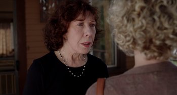 Movie still from “Grandma” (2015), directed by Paul Weitz – An older woman wearing a black shirt and a pearl necklace; Close Up shot, Over the shoulder angle