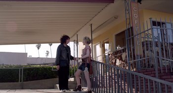 Movie still from “Grandma” (2015), directed by Paul Weitz – Two women standing on a porch next to a railing; Wide shot, Low angle