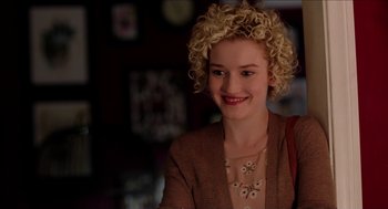 Movie still from “Grandma” (2015), directed by Paul Weitz – A woman with blonde curly hair smiling for the camera; Close Up shot, Over the shoulder angle