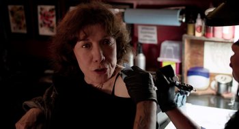 Movie still from “Grandma” (2015), directed by Paul Weitz – A woman in black shirt and black leather gloves; Close Up shot, Low angle