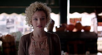 Movie still from “Grandma” (2015), directed by Paul Weitz – A woman with blonde curly hair wearing a pink dress; Close Up shot, Over the shoulder angle