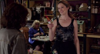 Movie still from “Grandma” (2015), directed by Paul Weitz – A woman holding a hot sauce bottle in her hand; Medium shot, Over the shoulder angle