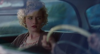 Movie still from “Grandma” (2015), directed by Paul Weitz – A woman sitting in the back seat of a car; Close Up shot, Over the shoulder angle