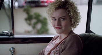Movie still from “Grandma” (2015), directed by Paul Weitz – A woman with blonde curly hair sitting on a bench; Close Up shot, Over the shoulder angle