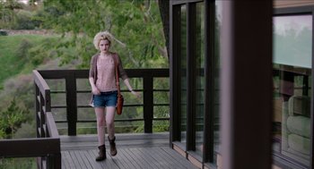 Movie still from “Grandma” (2015), directed by Paul Weitz – A woman walking on a porch with a purse; Wide shot, Over the shoulder angle