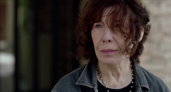 Movie still from “Grandma” (2015), directed by Paul Weitz – An older woman wearing a black shirt and a jean jacket; Close Up shot, Over the shoulder angle