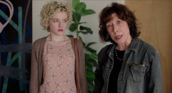 Movie still from “Grandma” (2015), directed by Paul Weitz – A woman standing next to a woman in a pink dress; Close Up shot, Over the shoulder angle