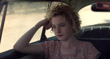Movie still from “Grandma” (2015), directed by Paul Weitz – A young woman sitting in the back seat of a car; Close Up shot, High angle