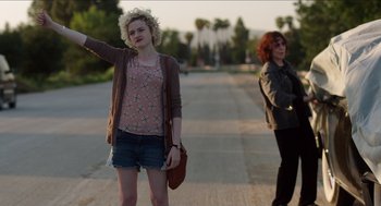 Movie still from “Grandma” (2015), directed by Paul Weitz – Two women standing on the side of a road; Medium shot, Low angle