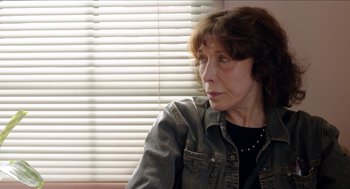 Movie still from “Grandma” (2015), directed by Paul Weitz – An older woman sitting in front of a window; Close Up shot, Over the shoulder angle