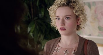 Movie still from “Grandma” (2015), directed by Paul Weitz – A woman with blonde curly hair wearing a necklace; Close Up shot, Over the shoulder angle