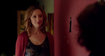 Movie still from “Grandma” (2015), directed by Paul Weitz – A woman standing in front of a red wall; Close Up shot, Over the shoulder angle