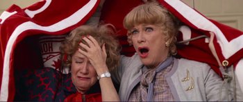 Movie still from “Grease 2” (1982), directed by Patricia Birch – Two older women with their hands on their heads; Close Up shot, High angle