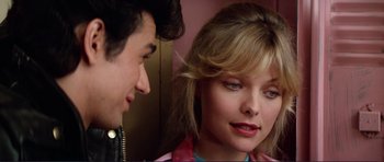 Movie still from “Grease 2” (1982), directed by Patricia Birch – A man and a woman looking at one another; Close Up shot, Over the shoulder angle