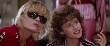 Movie still from “Grease 2” (1982), directed by Patricia Birch – Two women wearing sun glasses sitting next to each other; Close Up shot, Low angle
