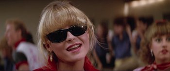 Movie still from “Grease 2” (1982), directed by Patricia Birch – A person wearing sunglasses; Close Up shot, Low angle