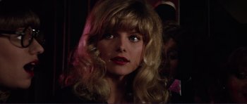 Movie still from “Grease 2” (1982), directed by Patricia Birch – A person with long hair; Close Up shot, Over the shoulder angle