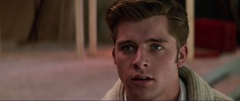 Movie still from “Grease 2” (1982), directed by Patricia Birch – A person looking at the camera; Close Up shot, Over the shoulder angle