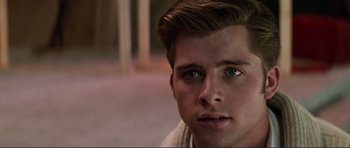 Movie still from “Grease 2” (1982), directed by Patricia Birch – A young man's eyes and face; Close Up shot, Over the shoulder angle