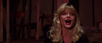 Movie still from “Grease 2” (1982), directed by Patricia Birch – A woman with long blonde curly hair and open mouth; Close Up shot, Low angle