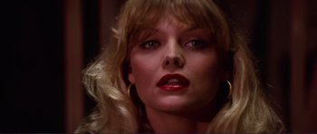 Movie still from “Grease 2” (1982), directed by Patricia Birch – A person with blonde hair and red lipstick; Close Up shot, Low angle