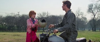 Movie still from “Grease 2” (1982), directed by Patricia Birch – A man and a woman on a motorcycle; Medium shot, Over the shoulder angle