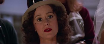 Movie still from “Grease 2” (1982), directed by Patricia Birch – A person wearing a hat; Close Up shot, Over the shoulder angle