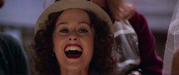 Movie still from “Grease 2” (1982), directed by Patricia Birch – A person wearing a hat and smiling; Close Up shot, Low angle