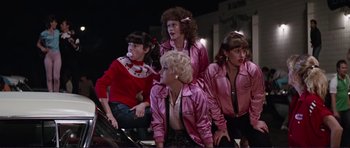 Movie still from “Grease 2” (1982), directed by Patricia Birch – A group of women dressed in pink jackets; Medium shot, Over the shoulder angle
