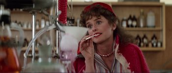 Movie still from “Grease 2” (1982), directed by Patricia Birch – A woman in a red hat is brushing her teeth in the mirror; Close Up shot, Over the shoulder angle