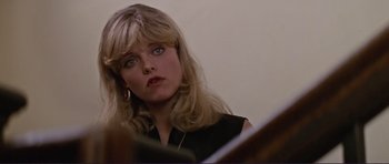 Movie still from “Grease 2” (1982), directed by Patricia Birch – A person sitting at a table; Close Up shot, Low angle