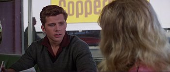 Movie still from “Grease 2” (1982), directed by Patricia Birch – A man and a woman are talking to each other; Close Up shot, Over the shoulder angle