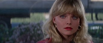 Movie still from “Grease 2” (1982), directed by Patricia Birch – A person with blonde hair and blue eyes; Close Up shot, Over the shoulder angle